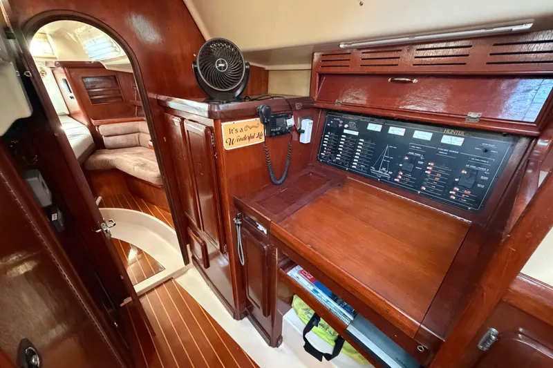 Slide: The Image of Interior of 1992 Hunter Passage 42 yacht with wooden cabinetry and control panel. - 32