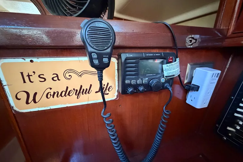 Slide: The Image of Radio equipment and sign inside a 1992 Hunter Passage 42 sailboat cabin. - 34