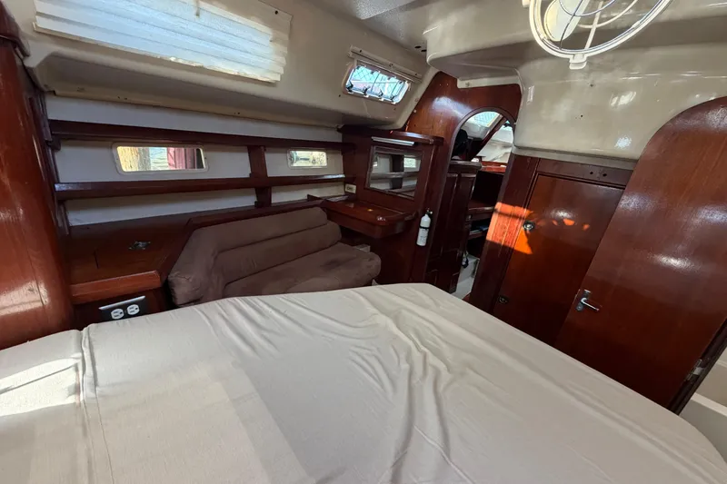 Slide: The Image of Interior of 1992 Hunter Passage 42 yacht with wood paneling and cozy seating area. - 39