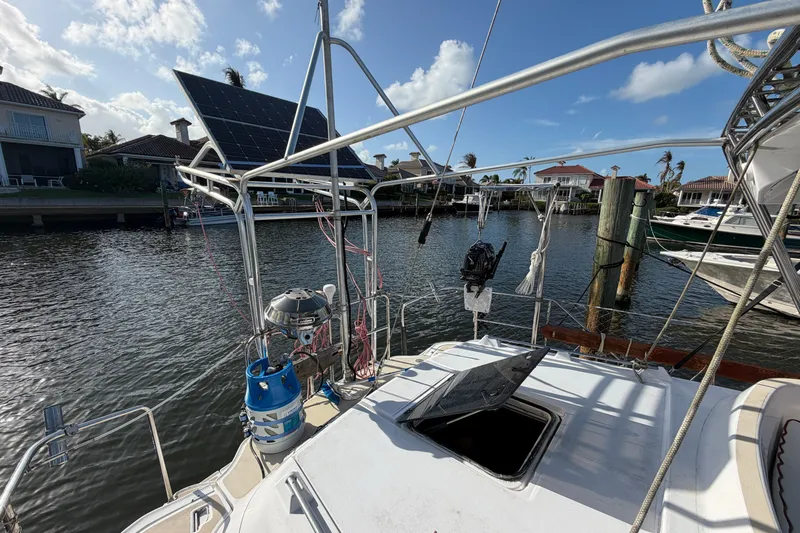 Slide: The Image of Sailboat Hunter Passage 42 (1992) with solar panels docked by waterfront homes. - 4