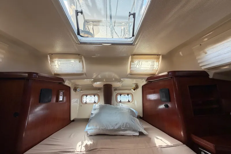 Slide: The Image of Cozy cabin interior of 1992 Hunter Passage 42 sailboat with skylight and wooden accents. - 40