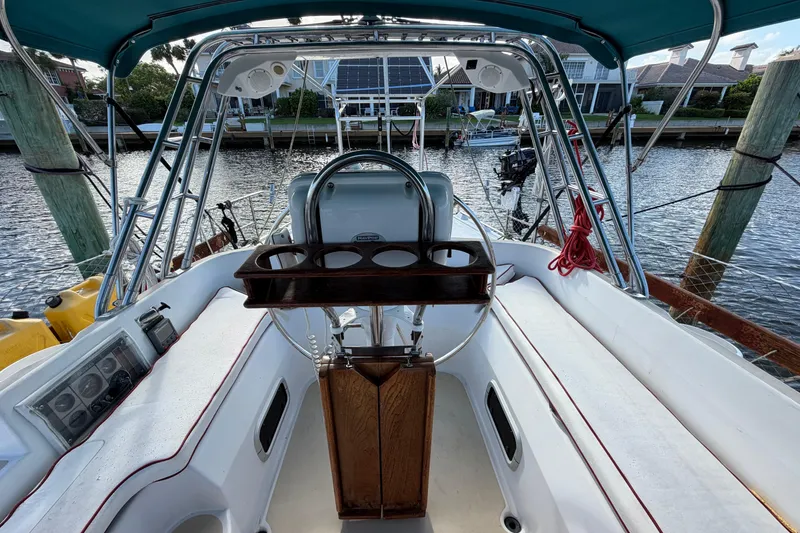 Slide: The Image of Cockpit of 1992 Hunter Passage 42 sailboat with steering wheel and cup holders. - 9