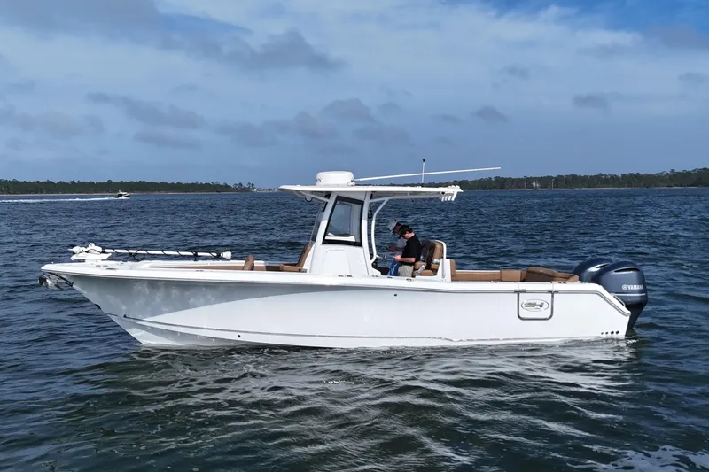 The Image of 2021 Sea Hunt Ultra 305 SE boat on calm water, side view. - 0
