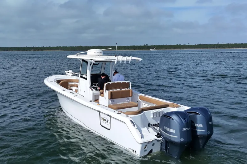 Slide: The Image of 2021 Sea Hunt Ultra 305 SE boat with twin Yamaha engines on open water. - 10