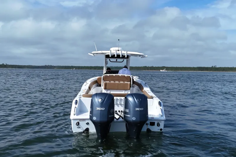Slide: The Image of 2021 Sea Hunt Ultra 305 SE boat with dual Yamaha engines on open water. - 11