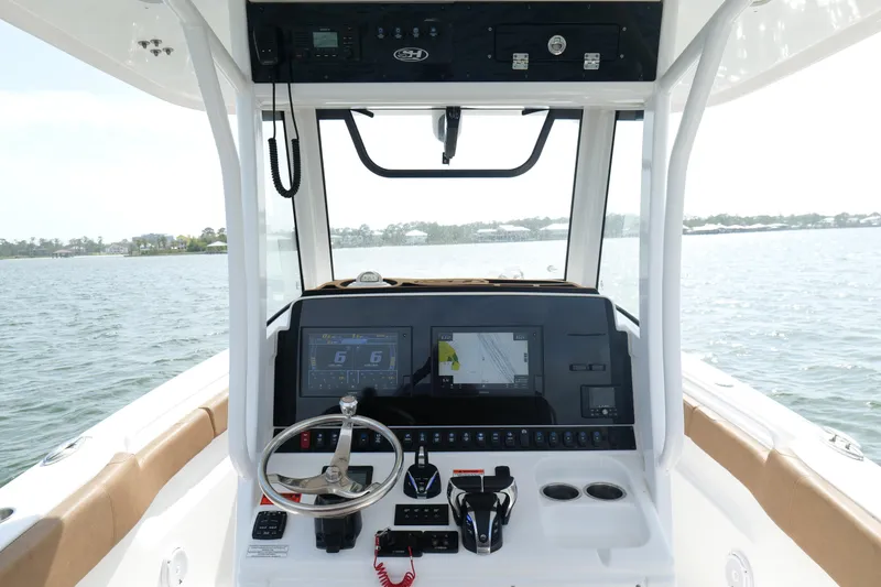 Slide: The Image of Cockpit view of 2021 Sea Hunt Ultra 305 SE boat on water. - 13