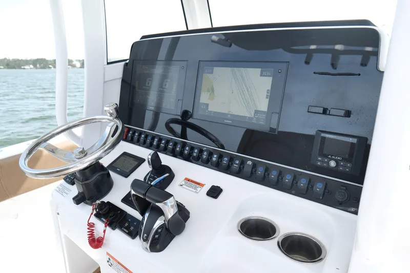 Slide: The Image of 2021 Sea Hunt Ultra 305 SE boat dashboard with navigation screens and controls. - 14