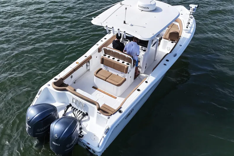 Slide: The Image of 2021 Sea Hunt Ultra 305 SE boat with dual Yamaha engines on open water. - 17