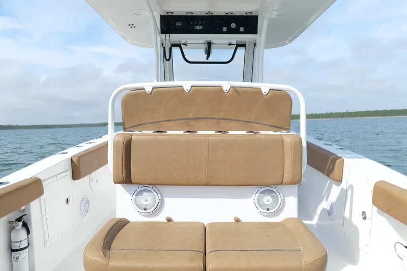 Slide: The Image of 2021 Sea Hunt Ultra 305 SE boat interior with tan seating on open water. - 18