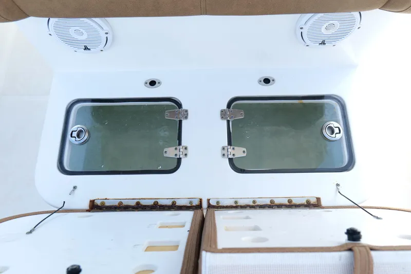 Slide: The Image of 2021 Sea Hunt Ultra 305 SE boat deck with dual livewell compartments and speakers. - 19