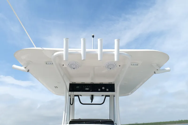 Slide: The Image of 2021 Sea Hunt Ultra 305 SE boat top view with rod holders and electronics against blue sky. - 23