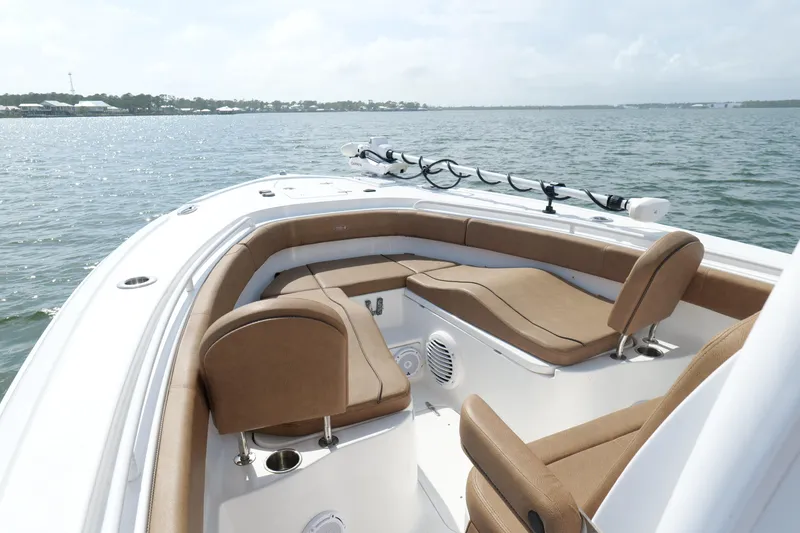 Slide: The Image of 2021 Sea Hunt Ultra 305 SE boat with tan seating on calm water. - 25