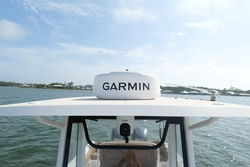 Slide: The Image of 2021 Sea Hunt Ultra 305 SE boat with Garmin radar on calm waters. - 29