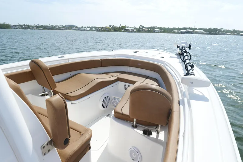 Slide: The Image of 2021 Sea Hunt Ultra 305 SE boat with tan seating on calm water. - 3