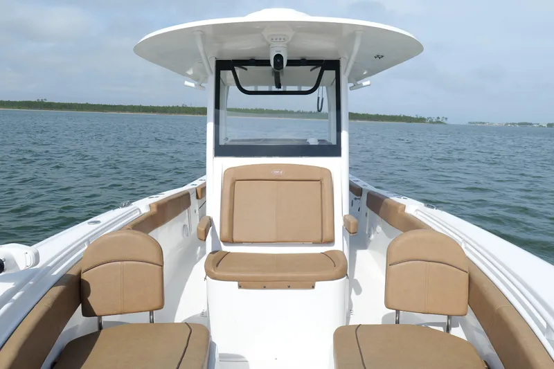 Slide: The Image of 2021 Sea Hunt Ultra 305 SE boat interior with tan seating on open water. - 4
