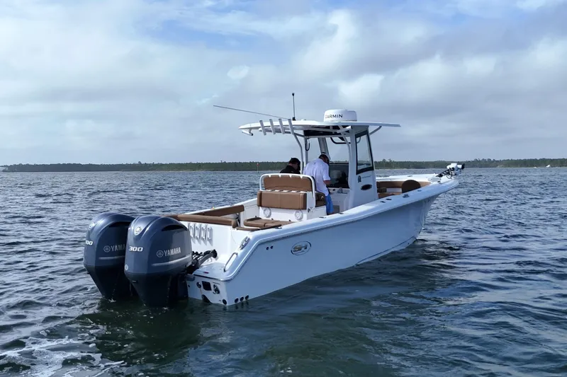 Slide: The Image of 2021 Sea Hunt Ultra 305 SE boat with dual Yamaha engines on open water. - 5