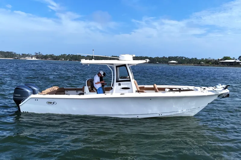 Slide: The Image of 2021 Sea Hunt Ultra 305 SE boat on calm water with clear sky. - 6
