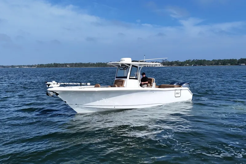 Slide: The Image of 2021 Sea Hunt Ultra 305 SE boat cruising on open water under clear skies. - 9
