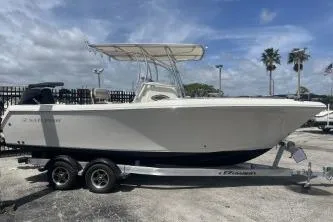 The Image of 2022 Sailfish 242 CC boat on trailer, parked outdoors under cloudy sky. - 1