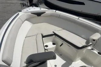 Slide: The Image of 2022 Sailfish 242 CC boat interior with cushioned seating and storage. - 11