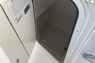 Slide: The Image of 2022 Sailfish 242 CC boat cabin door, sleek design, white interior. - 13