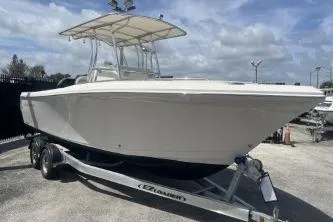 Slide: The Image of 2022 Sailfish 242 CC boat on trailer, under cloudy sky. - 3
