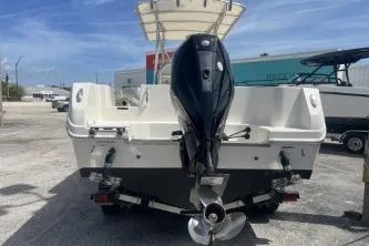 Slide: The Image of 2022 Sailfish 242 CC boat with outboard motor, parked on a trailer. - 7