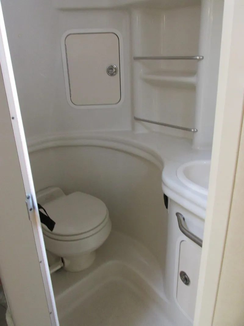 Slide: The Image of 2006 Sea Ray 300 Sundancer bathroom with toilet and sink. - 17