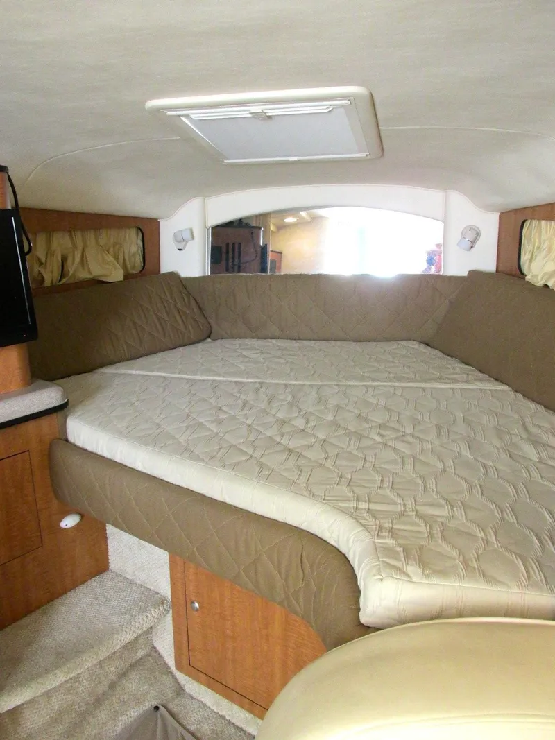 Slide: The Image of Interior of a 2006 Sea Ray 300 Sundancer with cozy bed. - 23
