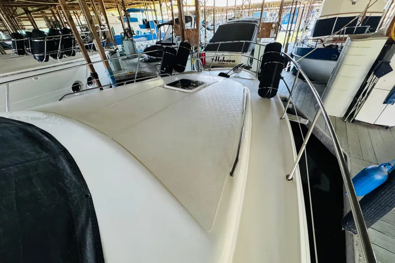 Slide: The Image of 2000 Sea Ray 400 Sedan Bridge yacht docked in a marina, showcasing sleek deck design. - 10