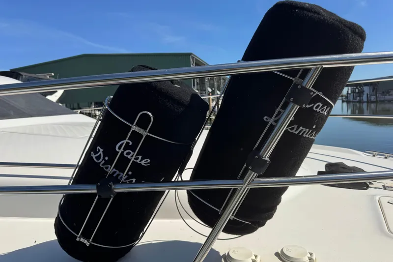 Slide: The Image of 2000 Sea Ray 400 Sedan Bridge with black fender covers, docked near marina. - 18