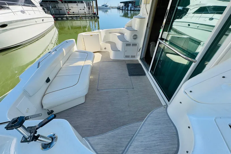 Slide: The Image of 2000 Sea Ray 400 Sedan Bridge yacht deck with seating and water view. - 19