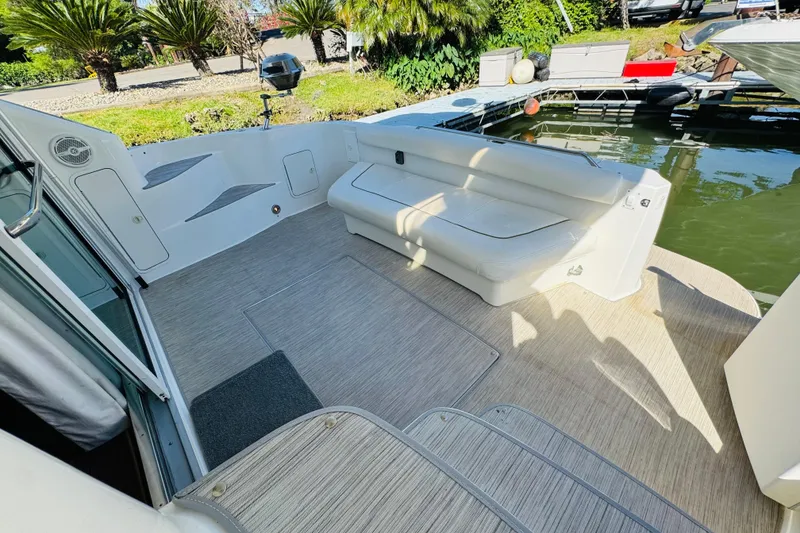 Slide: The Image of Spacious deck of 2000 Sea Ray 400 Sedan Bridge with seating and water view. - 20