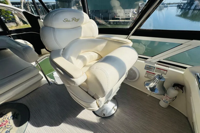 Slide: The Image of Luxurious captain's chair on 2000 Sea Ray 400 Sedan Bridge yacht, overlooking serene marina. - 27