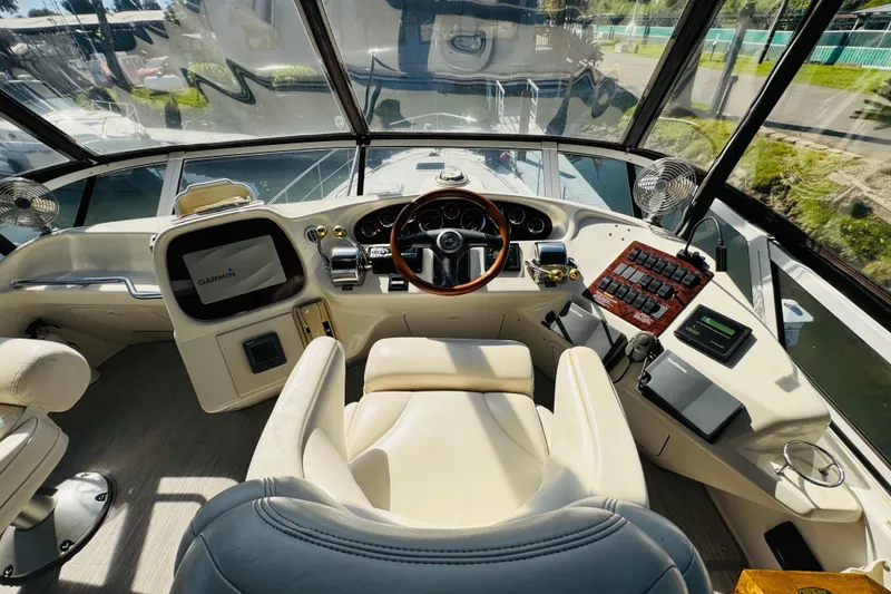 Slide: The Image of Cockpit of 2000 Sea Ray 400 Sedan Bridge with Garmin navigation system and luxurious seating. - 28