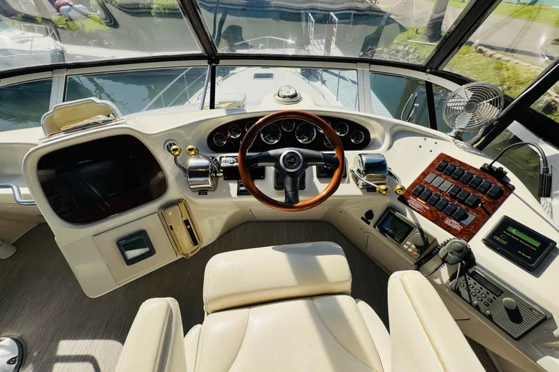 Slide: The Image of Cockpit view of 2000 Sea Ray 400 Sedan Bridge with steering wheel and control panel. - 30