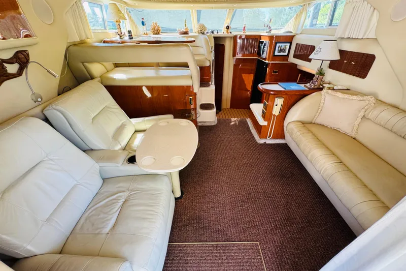 Slide: The Image of Luxurious interior of a 2000 Sea Ray 400 Sedan Bridge yacht with plush seating. - 35