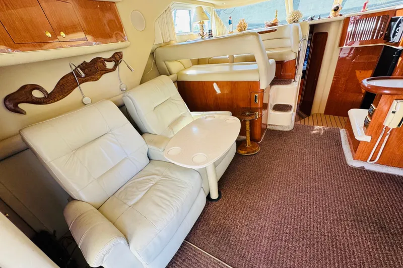 Slide: The Image of Interior of 2000 Sea Ray 400 Sedan Bridge with plush seating and elegant wood finishes. - 36