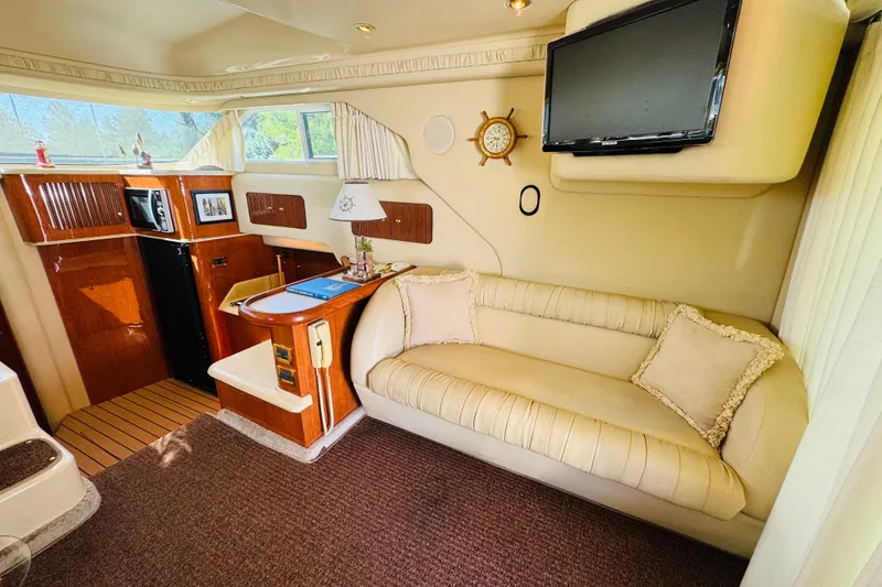 Slide: The Image of Luxurious interior of 2000 Sea Ray 400 Sedan Bridge with sofa, TV, and kitchenette. - 37