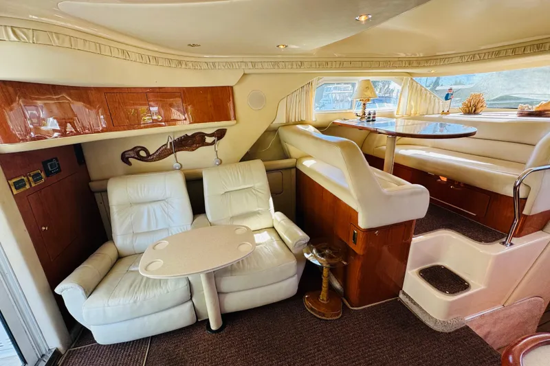 Slide: The Image of Luxurious interior of a 2000 Sea Ray 400 Sedan Bridge yacht with plush seating. - 38