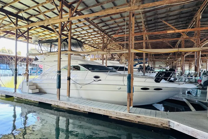 Slide: The Image of 2000 Sea Ray 400 Sedan Bridge yacht docked in a covered marina. - 4