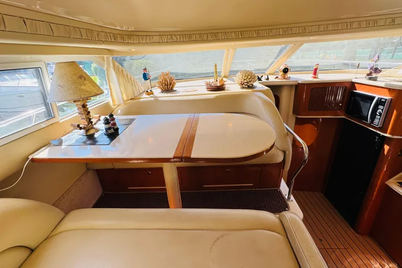 Slide: The Image of Interior of 2000 Sea Ray 400 Sedan Bridge yacht with dining area and decor. - 41