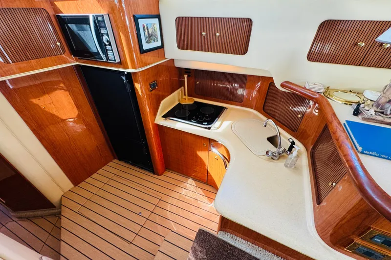 Slide: The Image of Luxurious kitchen interior of 2000 Sea Ray 400 Sedan Bridge yacht. - 46