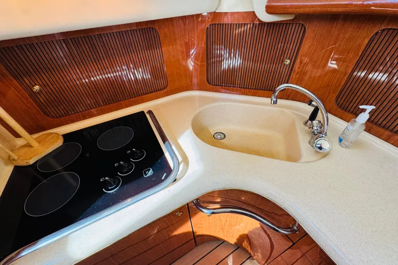 Slide: The Image of Luxurious kitchen area in a 2000 Sea Ray 400 Sedan Bridge yacht with stove and sink. - 50