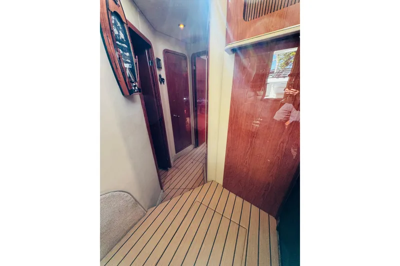 Slide: The Image of Interior hallway of 2000 Sea Ray 400 Sedan Bridge yacht with wooden finishes. - 51