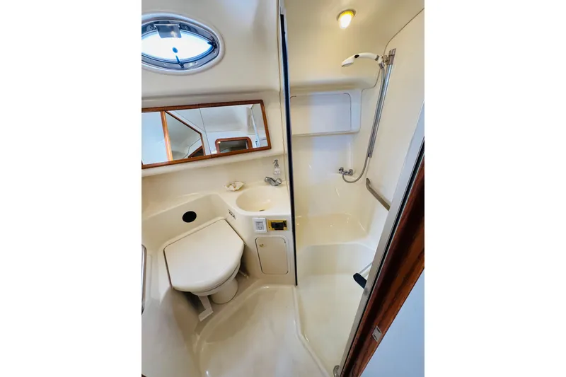 Slide: The Image of Bathroom interior of 2000 Sea Ray 400 Sedan Bridge yacht, featuring shower and sink. - 54