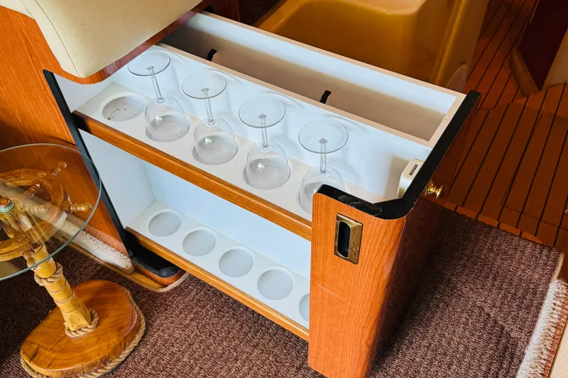 Slide: The Image of Interior of 2000 Sea Ray 400 Sedan Bridge with built-in glass holder and wooden accents. - 58