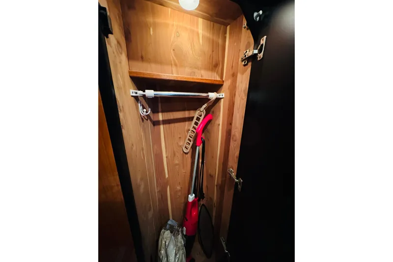 Slide: The Image of Wooden closet interior on a 2000 Sea Ray 400 Sedan Bridge yacht. - 62