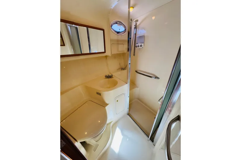 Slide: The Image of Bathroom interior of 2000 Sea Ray 400 Sedan Bridge yacht, featuring shower and sink. - 63