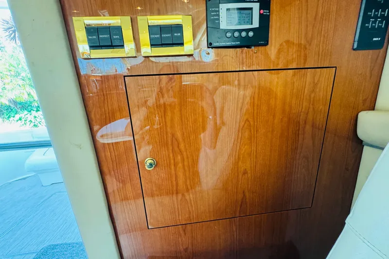 Slide: The Image of Control panel on a 2000 Sea Ray 400 Sedan Bridge yacht with wood finish. - 64